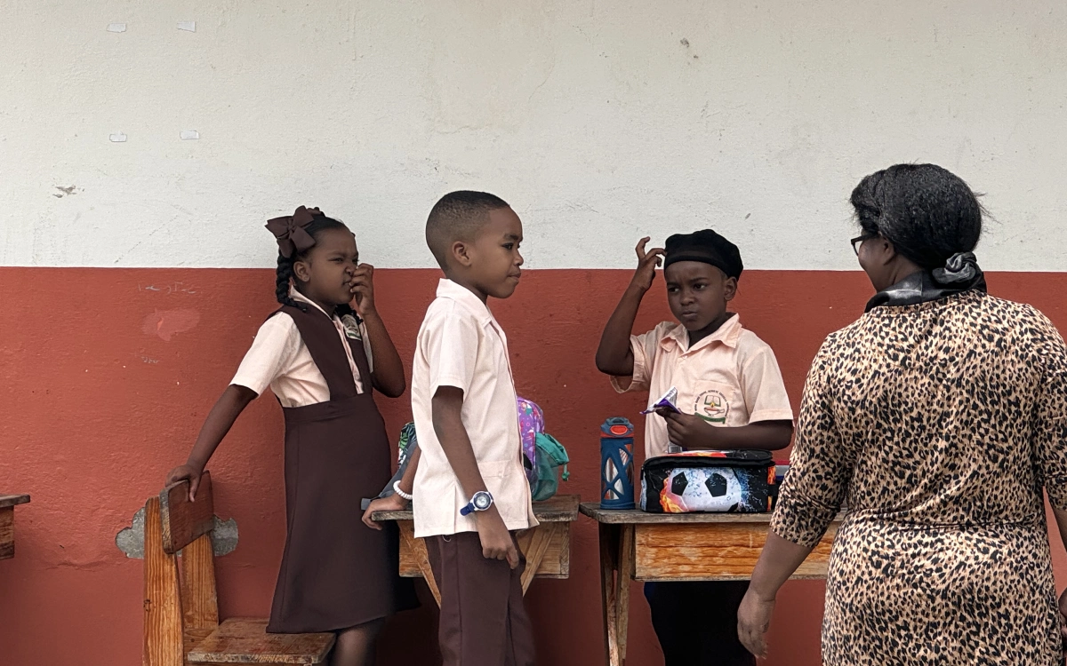 A group of children standing around each other.