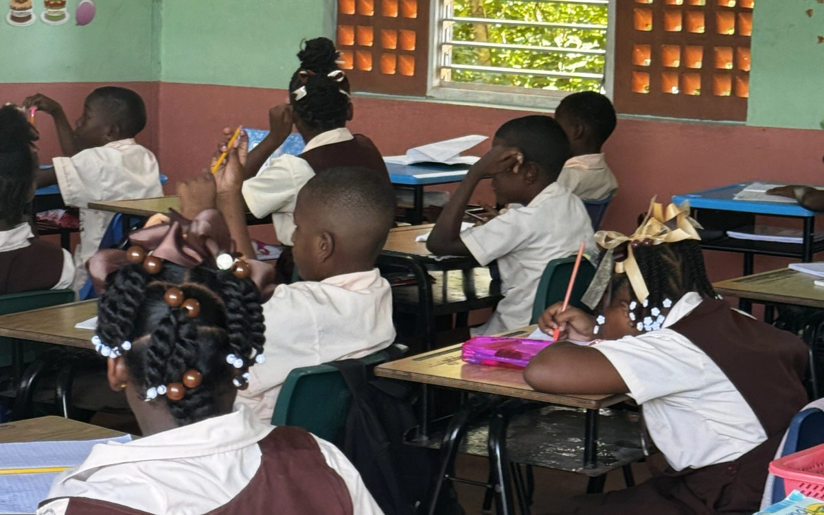 A group of children sitting at desks in a classroom.