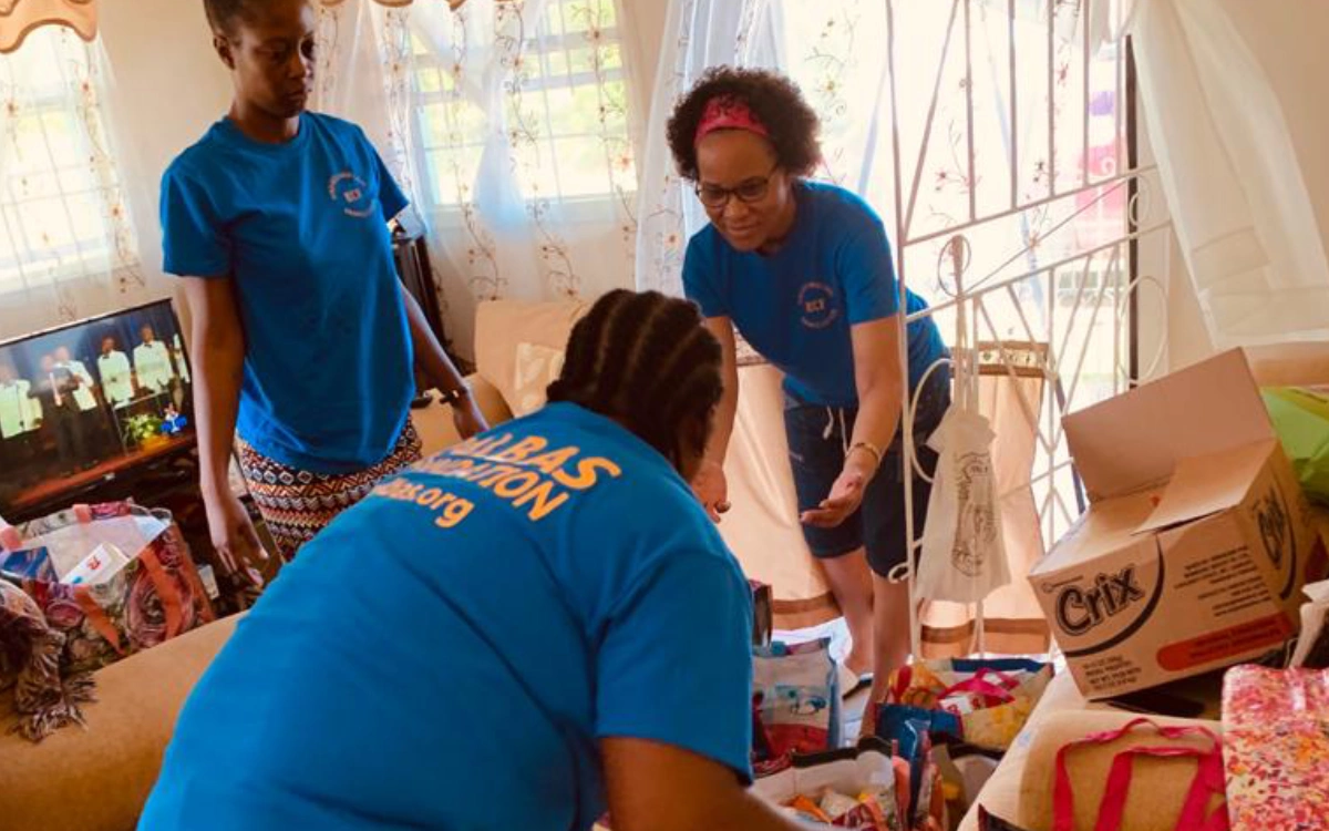 A group of people in blue shirts playing with toys.