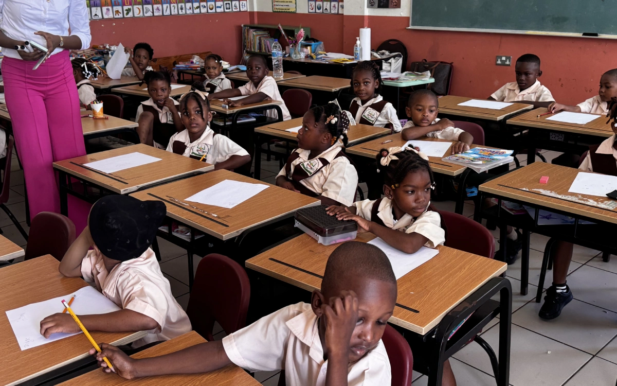 A group of children sitting at desks in a classroom.