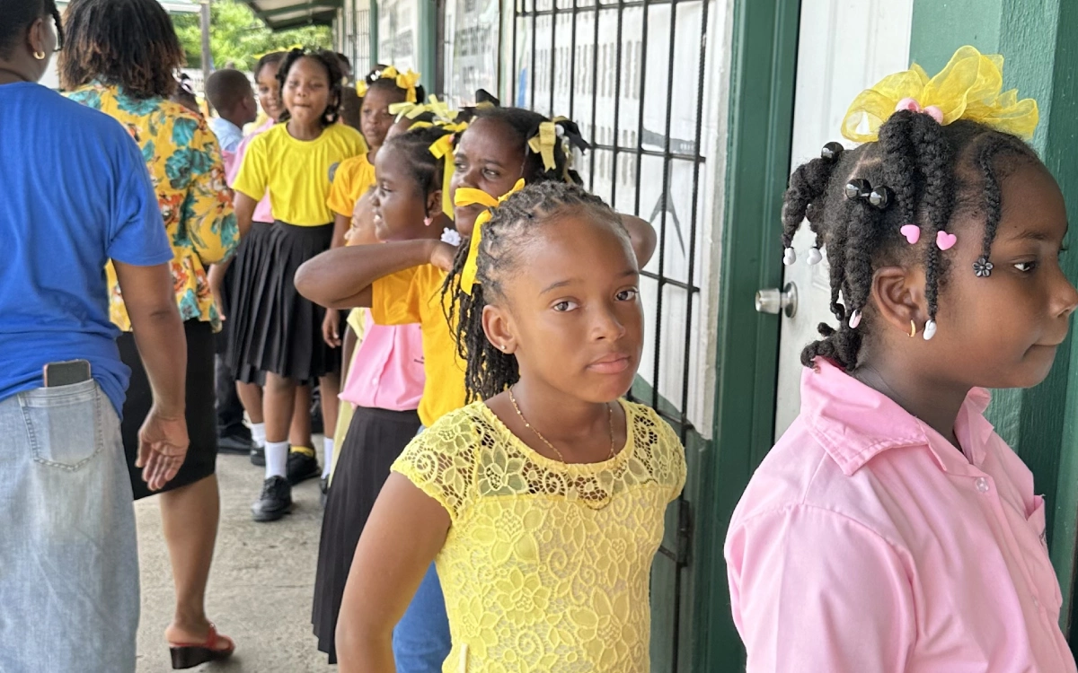 A group of children standing in line at school.